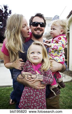 Caucasian family standing in backyard View Large Photo Image Stock Image - Caucasian family standing in backyard. Fotosearch