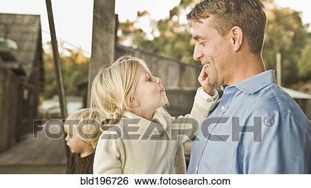 Stock Photograph - Caucasian father and children outdoors. Fotosearch