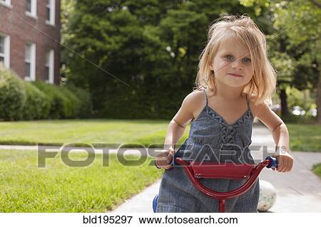 Stock Photo - Caucasian girl riding bicycle. Fotosearch