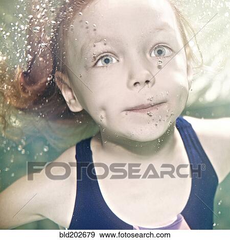 Stock Photo - Caucasian girl swimming under water. Fotosearch