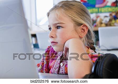 Stock Photograph - Caucasian girl using computer. Fotosearch