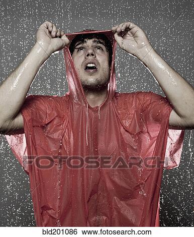 Stock Photograph - Caucasian man caught in the rain. Fotosearch