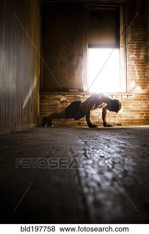 Stock Photo - Caucasian man doing push-ups. Fotosearch