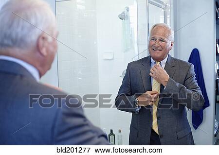 Caucasian man dressing in bathroom View Large Photo Image Stock Photo - Caucasian man dressing in bathroom. Fotosearch