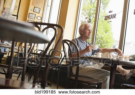 Caucasian man drinking coffee in restaurant View Large Photo Image Stock Photography - Caucasian man drinking coffee in restaurant. Fotosearch
