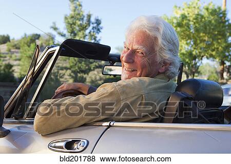 Caucasian man driving convertible View Large Photo Image Stock Photo - Caucasian man driving convertible. Fotosearch