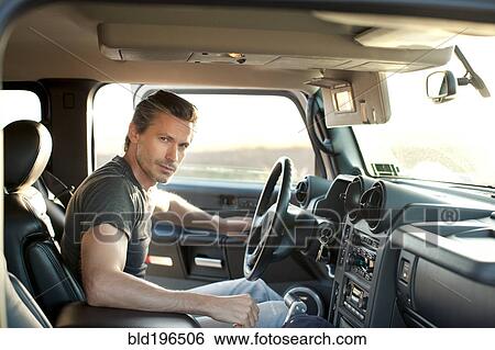 Stock Photograph - Caucasian man getting into truck. Fotosearch