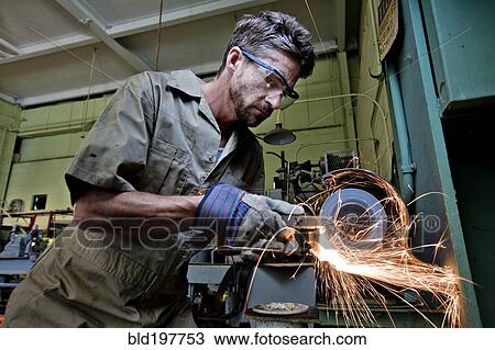 Caucasian man grinding metal in workshop View Large Photo Image Stock Image - Caucasian man grinding metal in workshop. Fotosearch