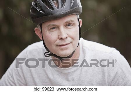 Stock Image - Caucasian man in bicycle helmet. Fotosearch