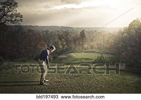 Stock Image - Caucasian man playing golf. Fotosearch