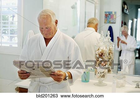 Caucasian man reading newspaper in bathroom View Large Photo Image Stock Image - Caucasian man reading newspaper in bathroom. Fotosearch