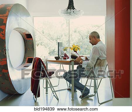 Caucasian man reading newspaper near metal sculpture View Large Photo Image Stock Photo - Caucasian man reading newspaper near metal sculpture. Fotosearch