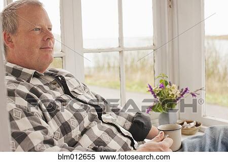 Caucasian man relaxing and drinking coffee View Large Photo Image Stock Photography - Caucasian man relaxing and drinking coffee. Fotosearch