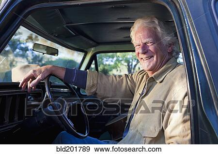 Stock Photo - Caucasian man sitting in truck. Fotosearch