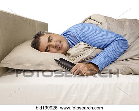 Caucasian man sleeping and holding telephone View Large Photo Image Stock Photograph - Caucasian man sleeping and holding telephone. Fotosearch