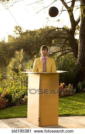 Caucasian man standing in large cardboard box outdoors View Large Photo Image Stock Image - Caucasian man standing in large cardboard box outdoors. Fotosearch