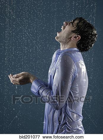 Stock Photo - Caucasian man taking a shower in clothing. Fotosearch