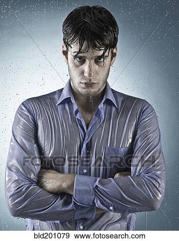 Stock Photo - Caucasian man taking a shower in clothing. Fotosearch