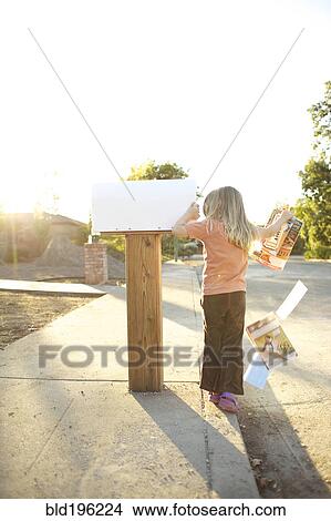 Picture - Caucasian man throwing mail out of mailbox. Fotosearch