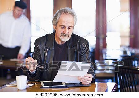 Caucasian man using tablet computer View Large Photo Image Stock Photograph - Caucasian man using tablet computer. Fotosearch