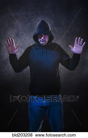 Stock Photo - Caucasian man wearing black hoodie. Fotosearch