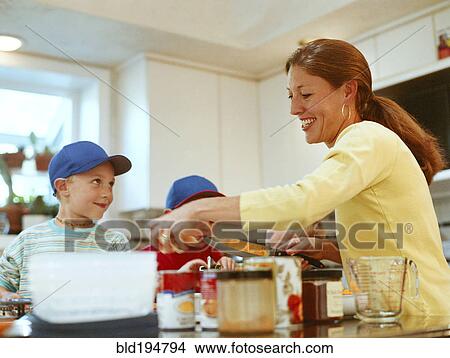 Picture - Caucasian mother and sons preparing food. Fotosearch