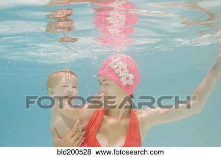Caucasian mother holding baby underwater View Large Photo Image Stock Photo - Caucasian mother holding baby underwater. Fotosearch