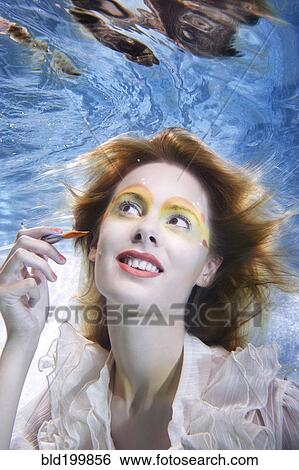Caucasian putting makeup on under water View Large Photo Image Stock Photograph - Caucasian putting makeup on under water. Fotosearch