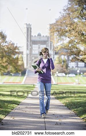 Caucasian student on cell phone on campus View Large Photo Image Stock Image - Caucasian student on cell phone on campus. Fotosearch