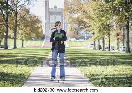 Stock Image - Caucasian student standing on campus. Fotosearch