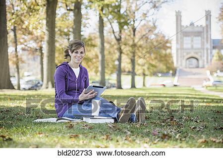Stock Image - Caucasian student studying on campus. Fotosearch