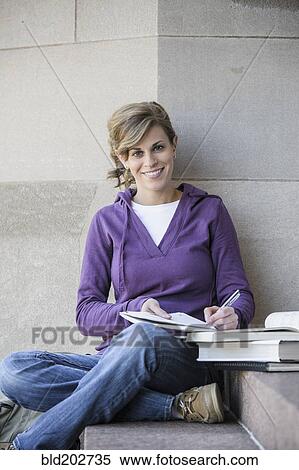 Stock Photography - Caucasian student studying on campus. Fotosearch