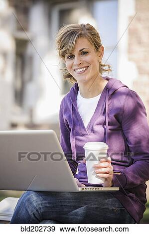 Caucasian student using laptop on campus View Large Photo Image Stock Photo - Caucasian student using laptop on campus. Fotosearch