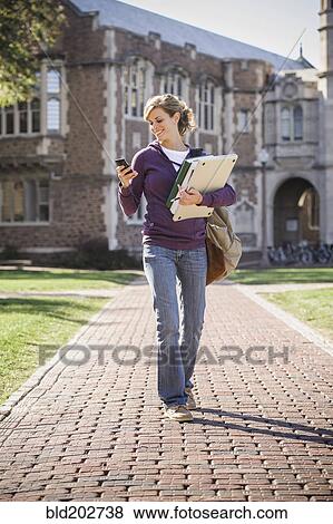 Caucasian student walking on campus View Large Photo Image Stock Photo - Caucasian student walking on campus. Fotosearch
