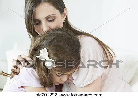 Caucasian woman comforting daughter View Large Photo Image Stock Image - Caucasian woman comforting daughter. Fotosearch