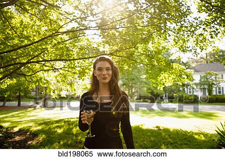 Caucasian woman drinking white wine in park View Large Photo Image Stock Photography - Caucasian woman drinking white wine in park. Fotosearch