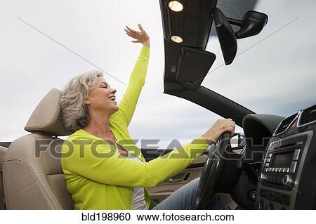 Caucasian woman driving convertible View Large Photo Image Stock Image - Caucasian woman driving convertible. Fotosearch