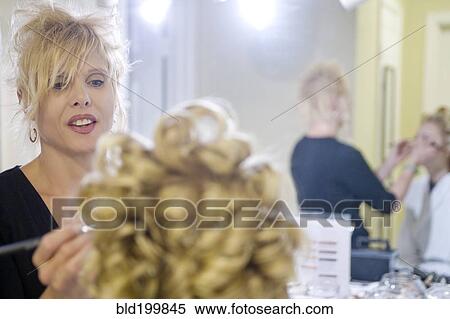 Stock Photography - Caucasian woman having her hair and makeup done. Fotosearch