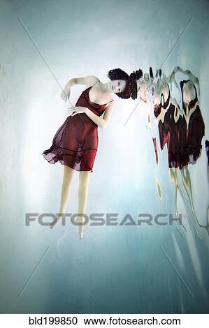 Caucasian woman in dress swimming under water View Large Photo Image Stock Image - Caucasian woman in dress swimming under water. Fotosearch