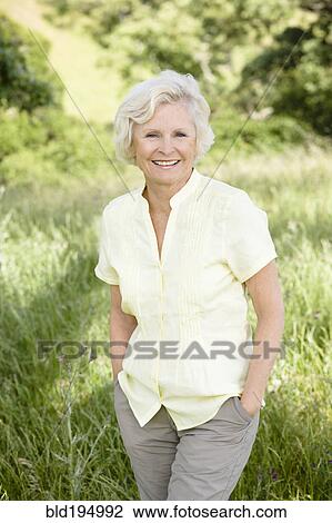 Caucasian woman in field with hands in pockets View Large Photo Image Stock Image - Caucasian woman in field with hands in pockets. Fotosearch