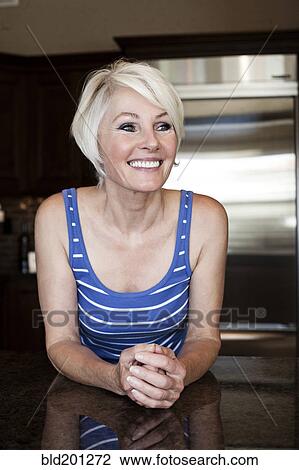 Caucasian woman in kitchen View Large Photo Image Stock Image - Caucasian woman in kitchen. Fotosearch