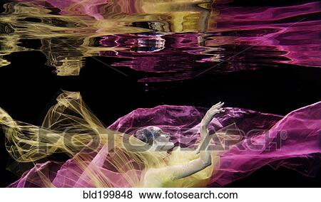 Caucasian woman in scarf swimming under water View Large Photo Image Stock Photo - Caucasian woman in scarf swimming under water. Fotosearch