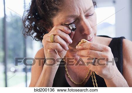 Caucasian woman looking at jewelry in jewelry store View Large Photo Image Stock Photograph - Caucasian woman looking at jewelry in jewelry store. Fotosearch