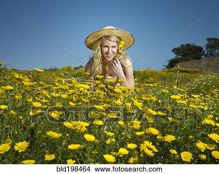 Caucasian woman picking wildflowers in field View Large Photo Image Picture - Caucasian woman picking wildflowers in field. Fotosearch