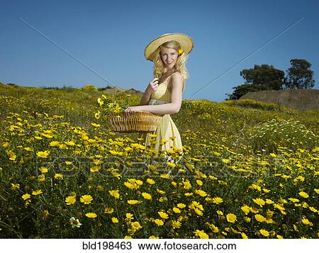 Caucasian woman picking wildflowers in field View Large Photo Image Stock Image - Caucasian woman picking wildflowers in field. Fotosearch