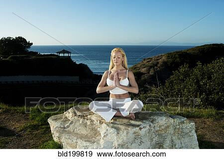 Caucasian woman practicing yoga near ocean View Large Photo Image Stock Photo - Caucasian woman practicing yoga near ocean. Fotosearch
