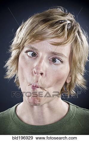 Stock Photo - Caucasian woman puckering her mouth. Fotosearch