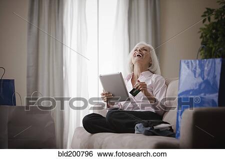 Caucasian woman shopping online with credit card View Large Photo Image Stock Photograph - Caucasian woman shopping online with credit card. Fotosearch