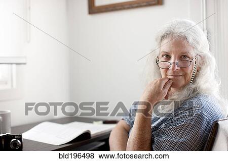 Caucasian woman sitting desk View Large Photo Image Stock Photo - Caucasian woman sitting desk. Fotosearch