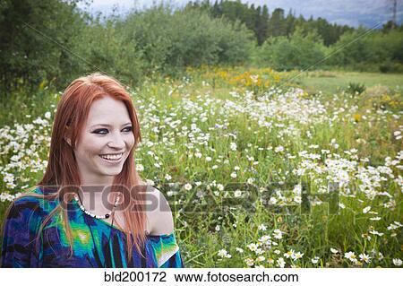 Stock Image - Caucasian woman standing in field. Fotosearch